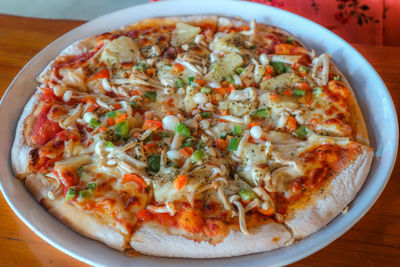 High angle view of pizza served on table