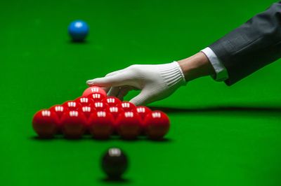 Cropped hand arranging snooker ball