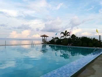 Scenic view of swimming pool by sea against sky