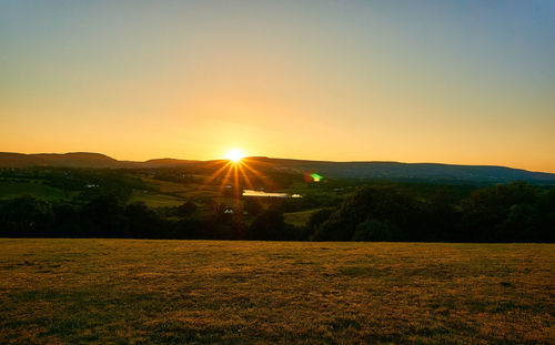 Scenic view of landscape against sky during sunset