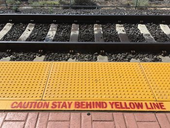 High angle view of text on railroad station platform