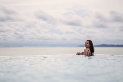 Portrait of woman swimming in sea