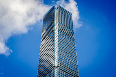 Low angle view of skyscrapers against blue sky