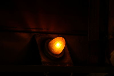 Close-up of illuminated lamp in darkroom