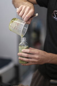 Midsection of man pouring glass