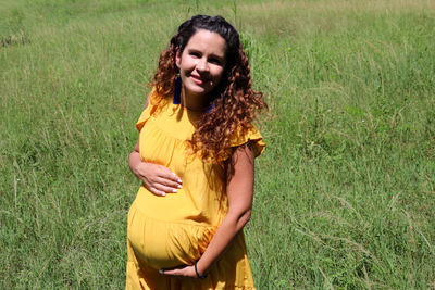 Happy woman standing on field