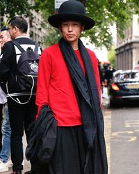 Portrait of woman in sun hat standing on road