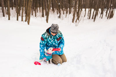 Rear view of person on snow covered field