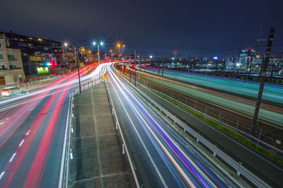 High angle view of light trails on highway at night