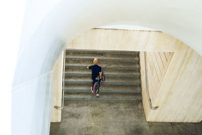 Rear view of woman walking on staircase