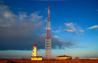 Low angle view of communications tower against blue sky