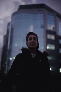 Man standing in illuminated city at night