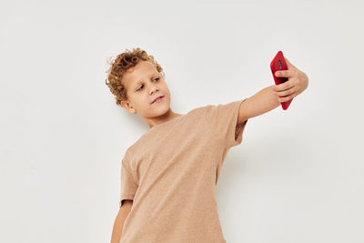 Boy taking selfie in studio