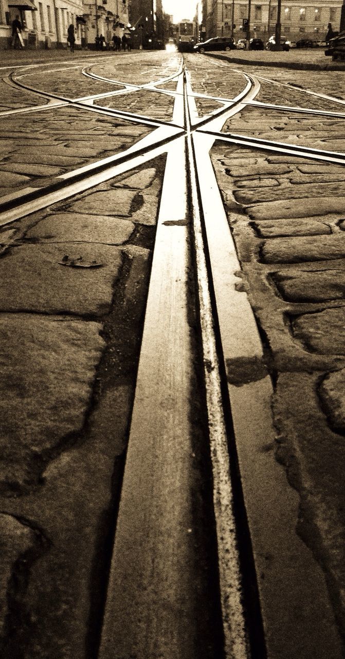 the way forward, diminishing perspective, vanishing point, transportation, railroad track, surface level, long, built structure, road marking, empty, road, architecture, asphalt, straight, day, no people, street, sunlight, outdoors, high angle view