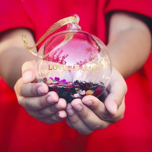 Midsection of person holding christmas ornament