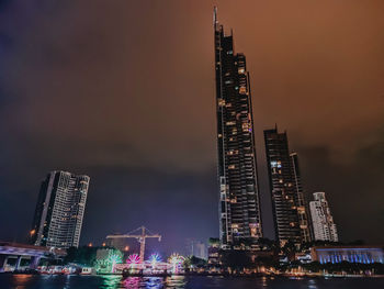 Illuminated modern buildings in city at night