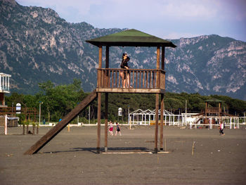 Mid adult women standing in hut at beach