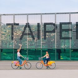 Side view of a man riding bicycle on city