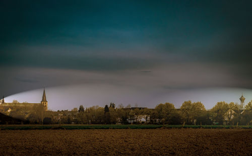 Panoramic view of trees and buildings against sky