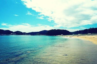 Scenic view of sea against cloudy sky