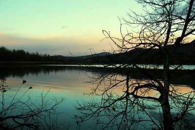 Scenic view of lake against sky during sunset