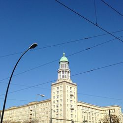 Low angle view of building against clear blue sky