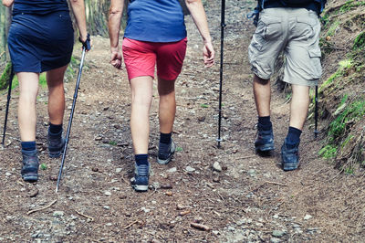 Low section of people walking on land