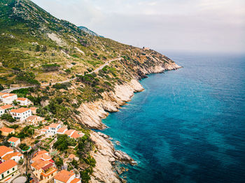 High angle view of sea and mountains against sky