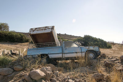 Wrecked and abandoned cars and ships in a remore location in the island