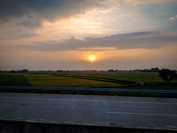 Scenic view of field against sky during sunset