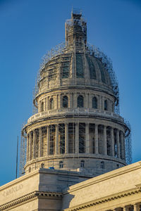 Low angle view of historical building against blue sky