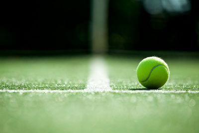 Close-up of tennis ball on playing field