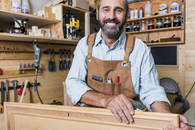 Portrait of smiling man working in workshop