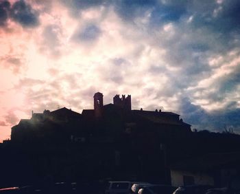 Silhouette city against sky during sunset