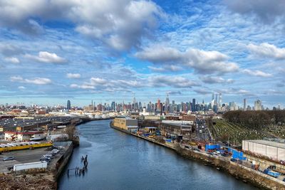 High angle view of river amidst buildings against sky