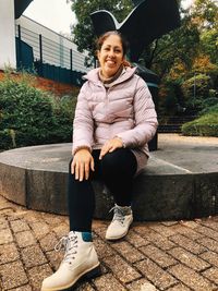 Portrait of teenage girl sitting outdoors