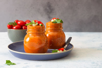 Traditional spanish soup gazpacho with cucumber and tomato garnish. summer cold tomato cream soup.