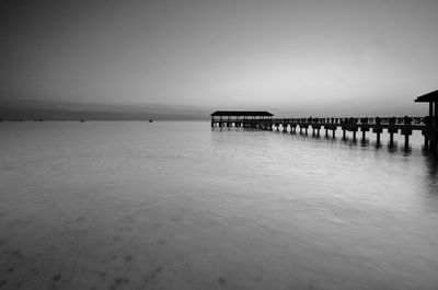 Pier on sea against clear sky