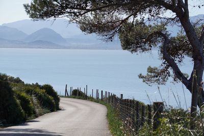 Road by sea against sky