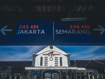 Low angle view of information sign against buildings in city