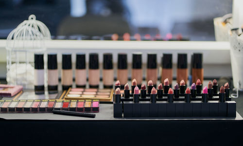 Makeup palettes, lipstick and foundation in a dressing table