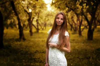 Portrait of beautiful young woman standing at park