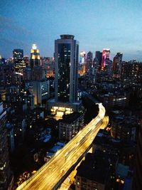 High angle view of illuminated cityscape against sky at night