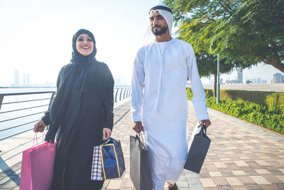 Full length of couple walking on footpath