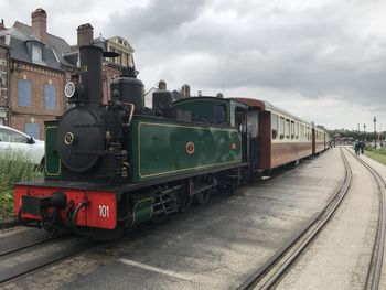 Train on railroad tracks against sky