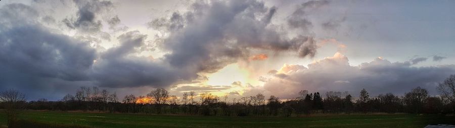 Panoramic view of field against sky during sunset