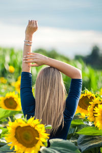 High angle view of woman by sunflower