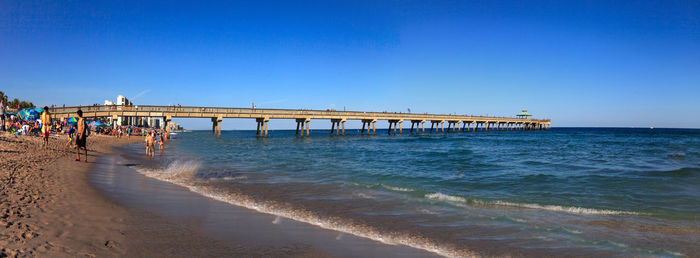 Deerfield beach pier under a blue sky in deerfield, florida