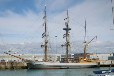 View of harbor against cloudy sky