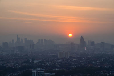 Cityscape against sky during sunset